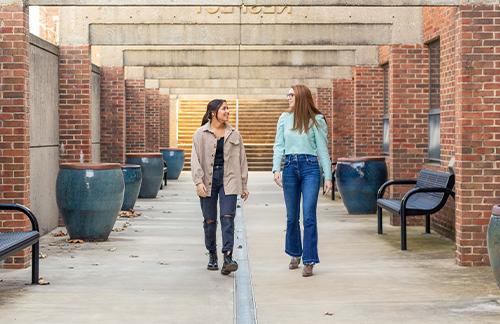 two girls walking on campus